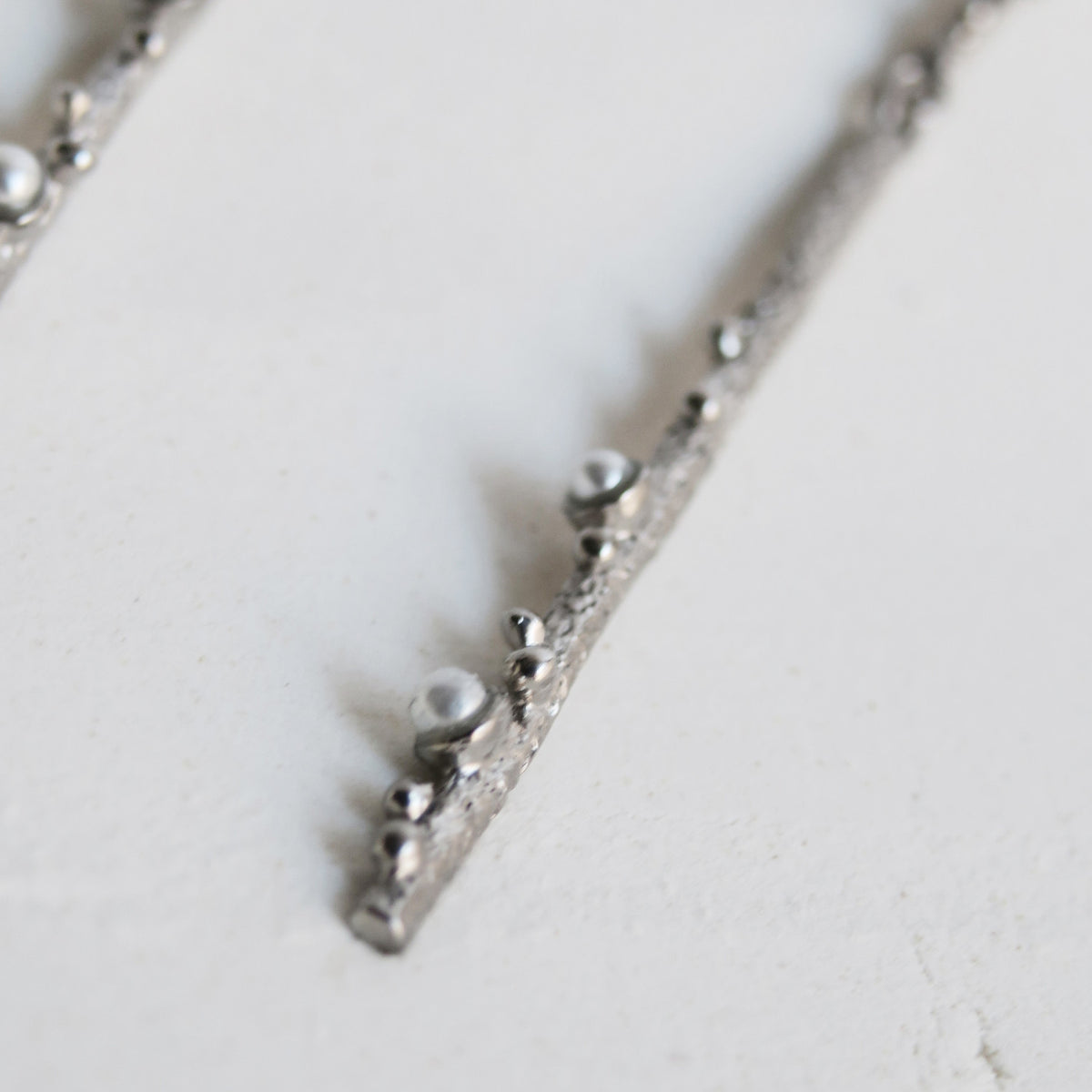 GUSPIRA EARRINGS LONG SILVER